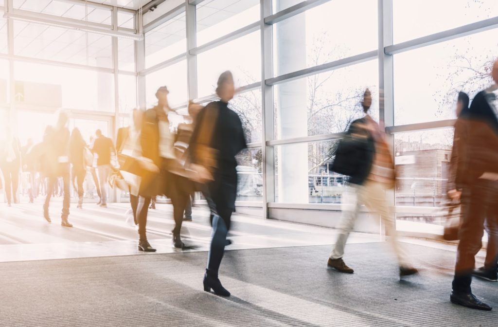 A group of blurred business people walking through a building