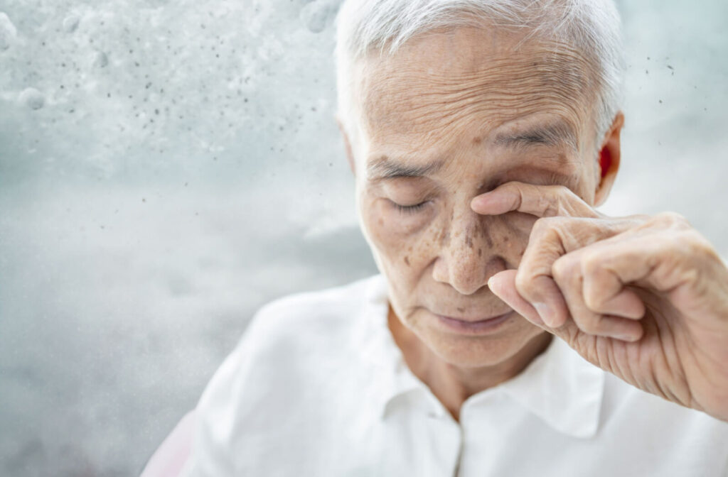 Close-up of an older man rubbing his closed eyes.