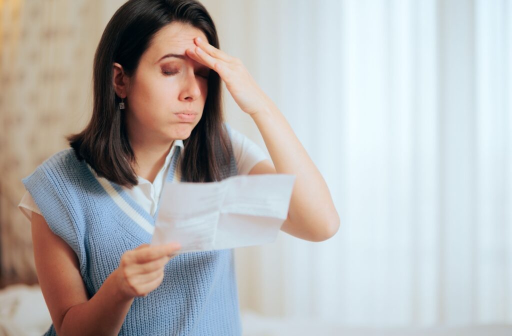 A woman shows discomfort from reading fine print for a long while.