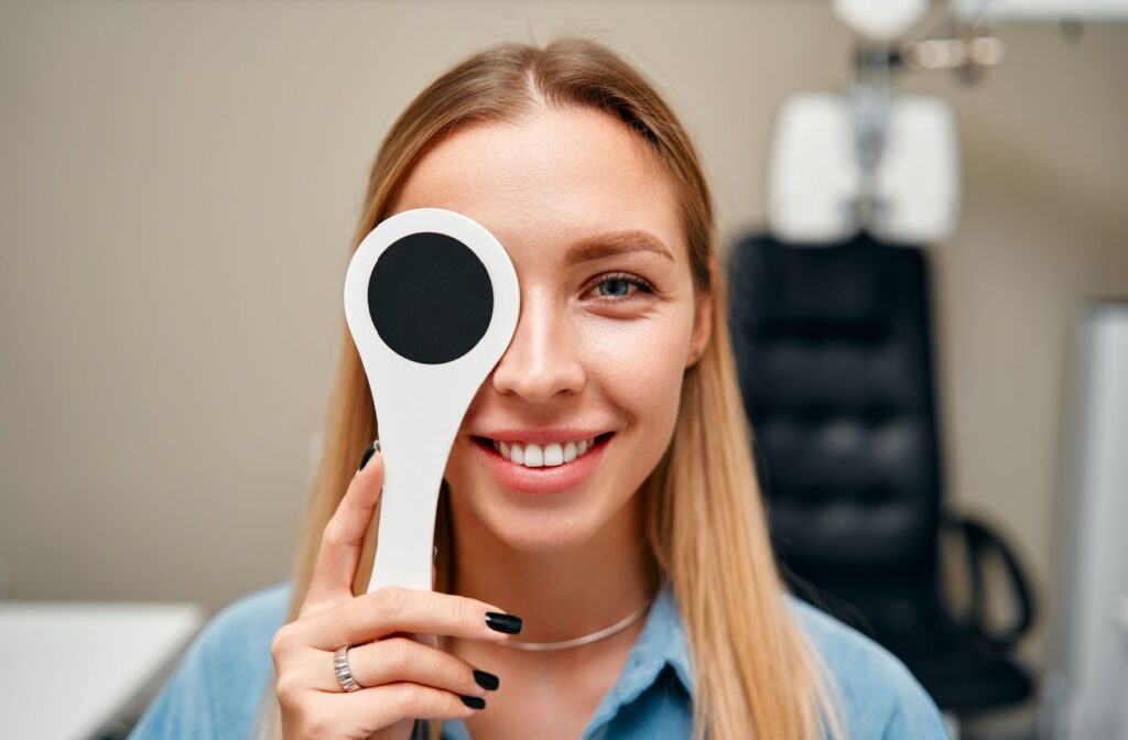 A young adult patient undergoes visual acuity testing as part of their comprehensive eye examination.