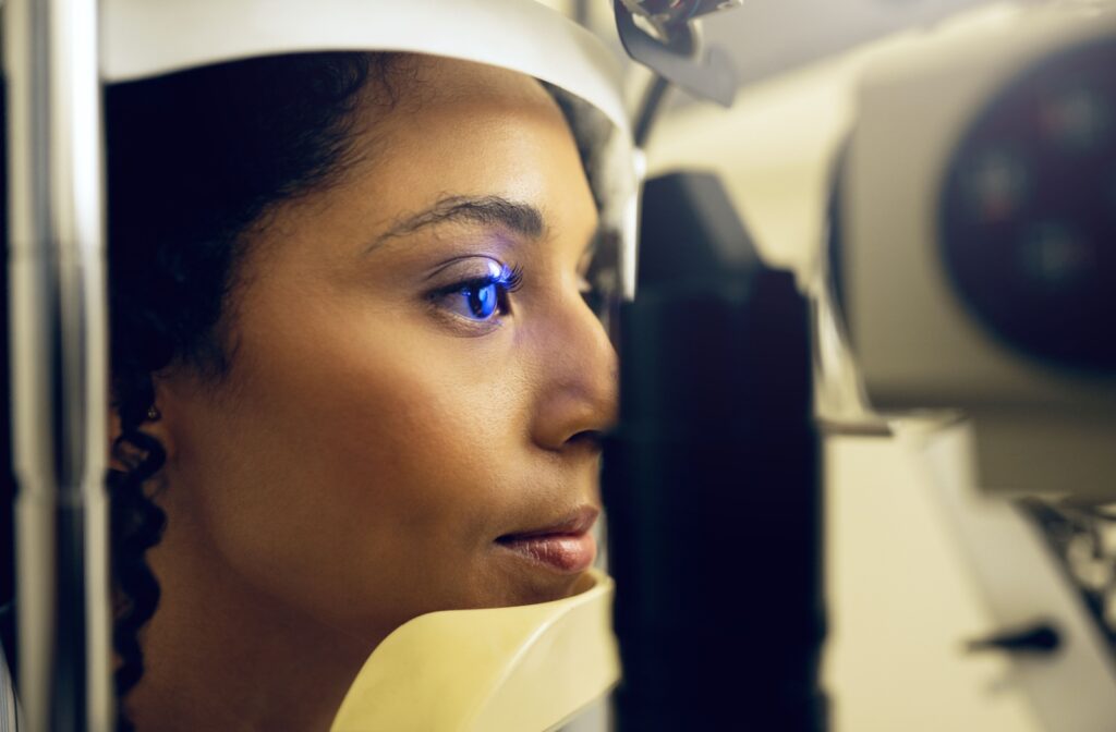 A patient undergoing a diabetic eye exam, with a laser used for detailed eye imaging