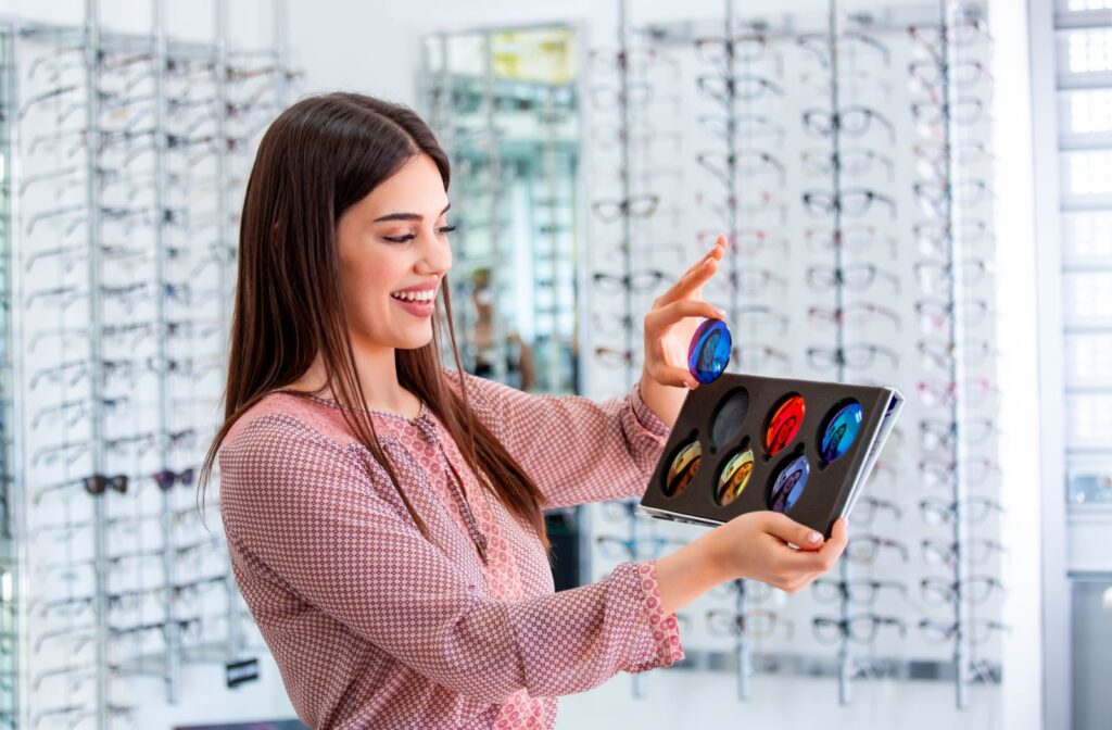 An optometrist holding a selection of polarized lens options.