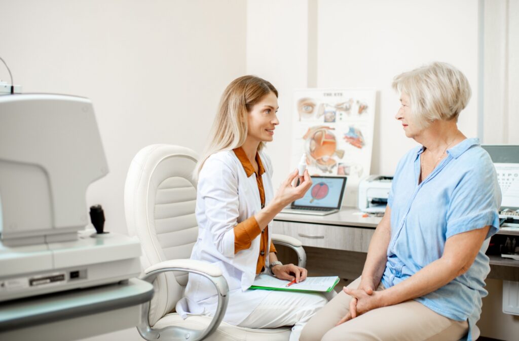 An eye doctor explains the potential risks of artificial tear misuse to a patient.