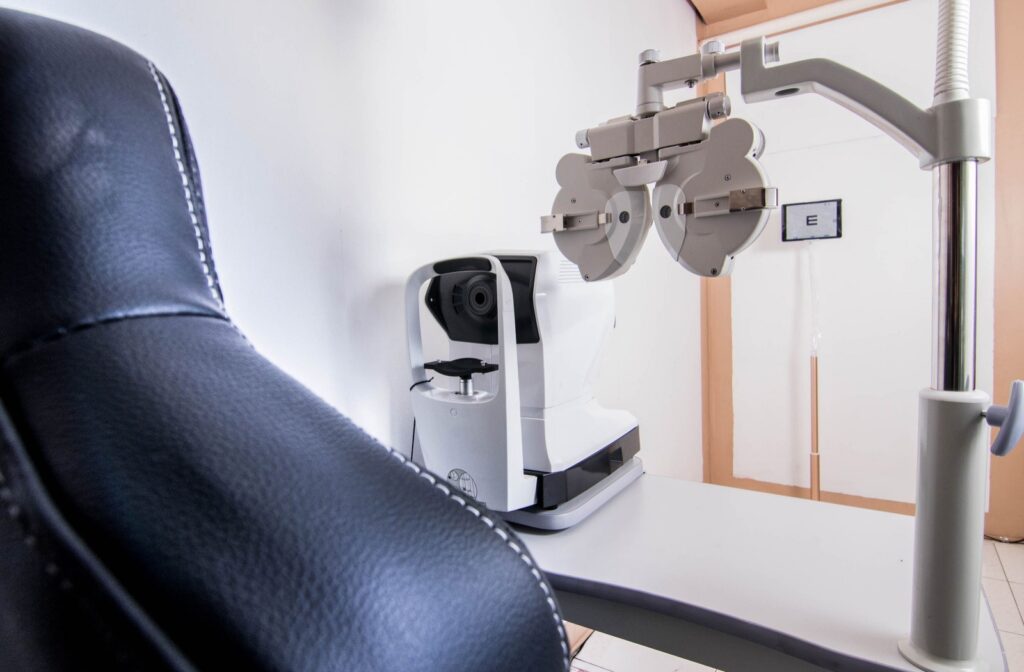 A close-up of eye exam equipment, including a phoropter and an autorefractor, in an optometry exam room.