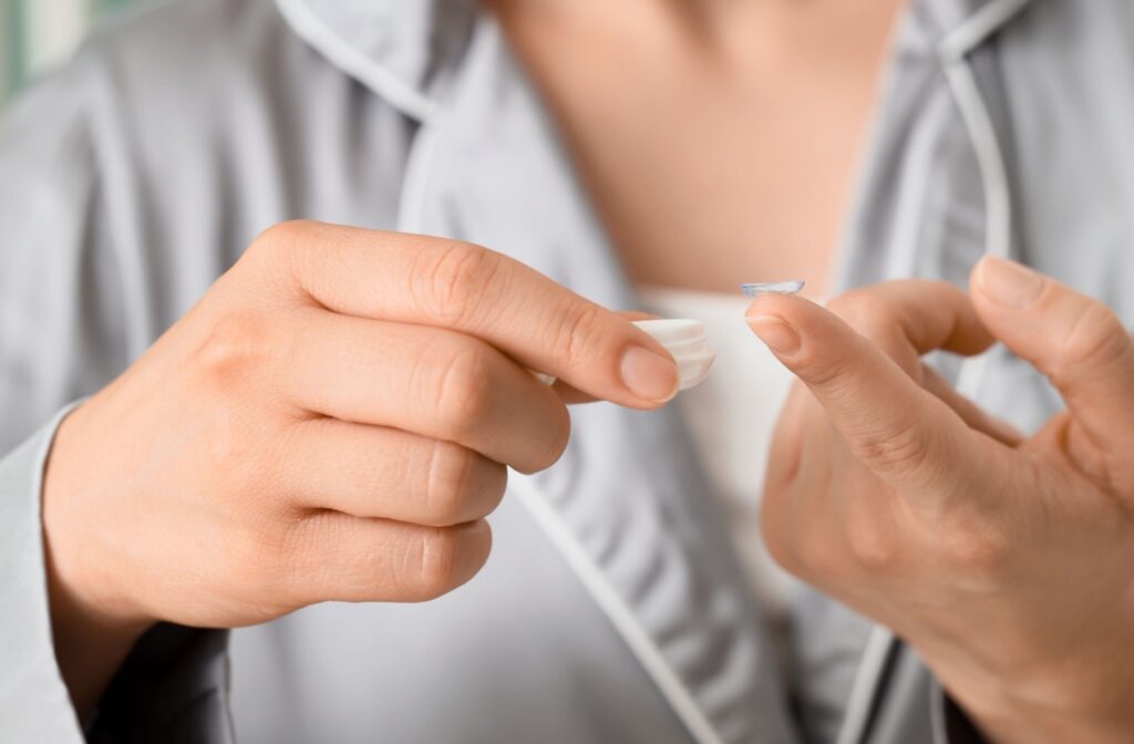 A close up of a person holding a contact lens on their finger